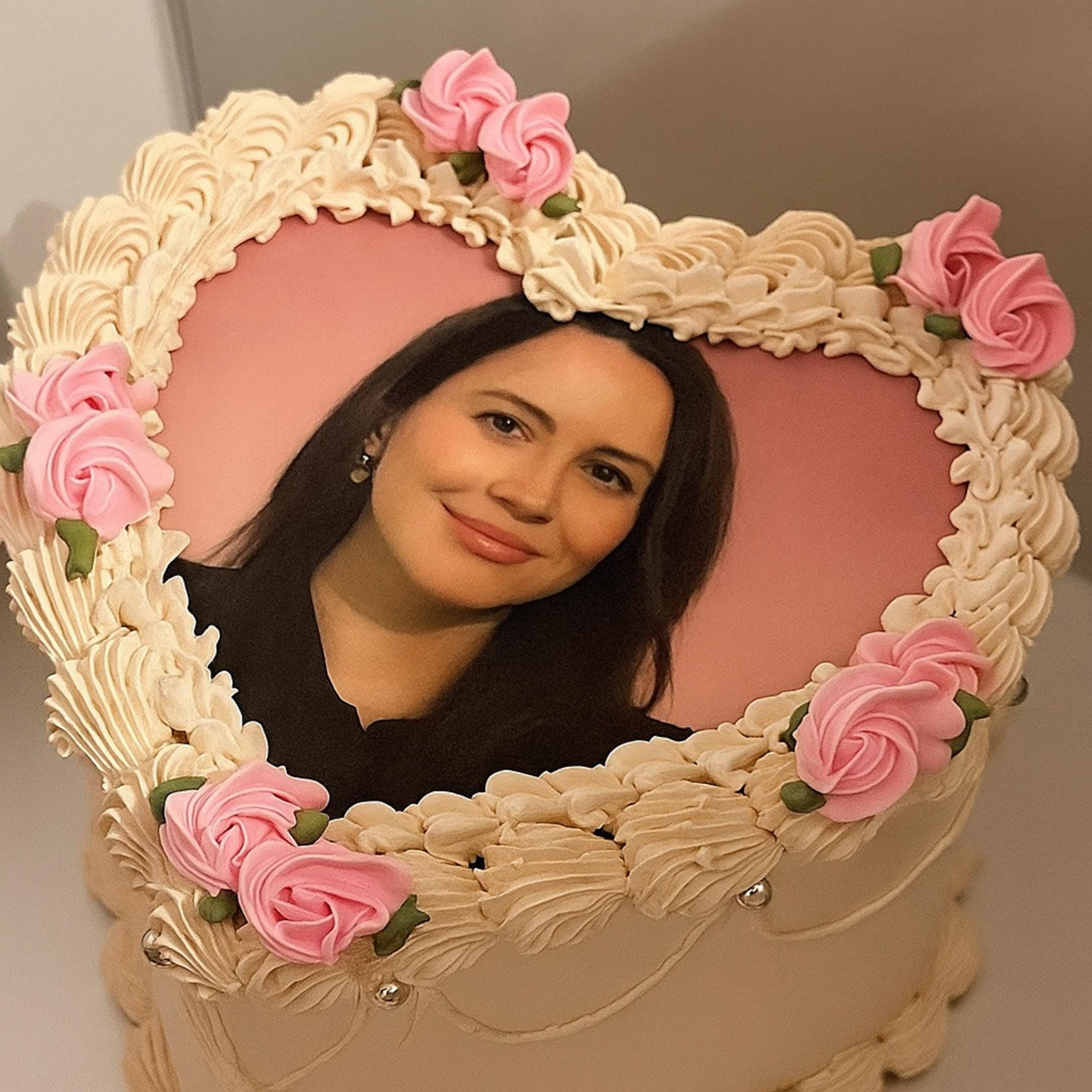 Custom heart photo edible cake topper printed on frosting sheet, ready to place on cake