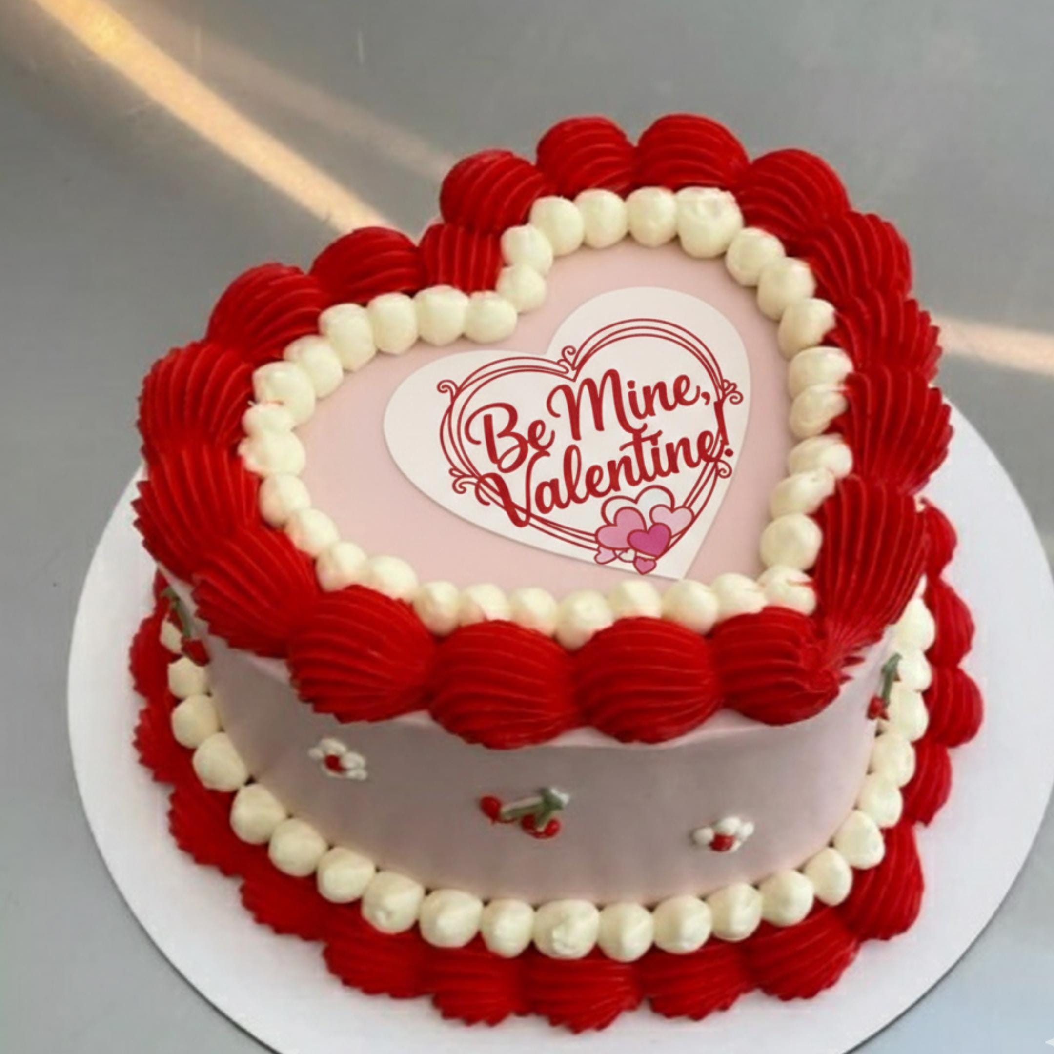 Heart shaped icing sheet cake topper with red heart frame and text "Be Mine Valentine" in script font.