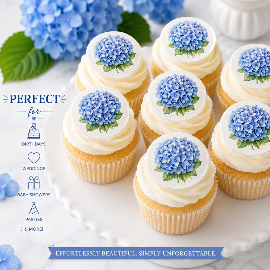 Vanilla cupcakes topped with blue hydrangea edible cupcake toppers arranged on a white cake stand with soft blue floral styling, demonstrating how the toppers look applied to frosted cupcakes.