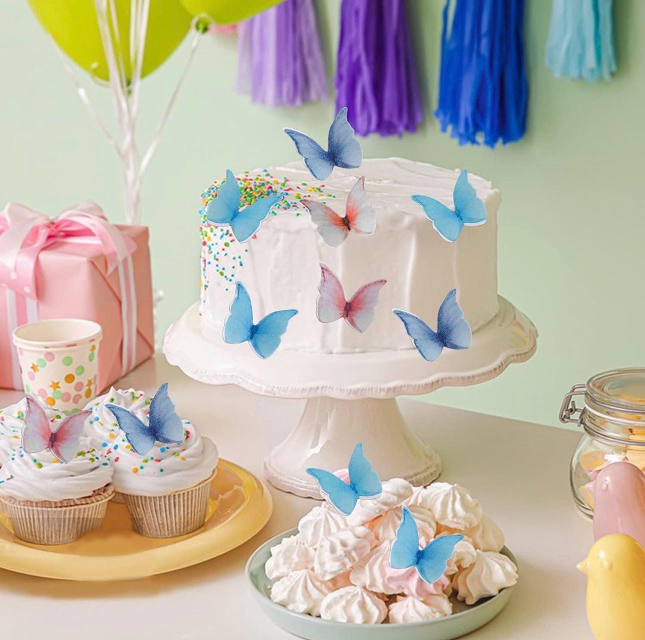 Colorful edible butterfly cake toppers made from rice wafer paper, featuring assorted sizes and vibrant designs. Set of 40 pre-cut butterflies for decorating cakes, cupcakes, cookies, desserts, fruit platters, and party treats. Lightweight edible decorations with foldable wings for a realistic 3D effect. Perfect for weddings, birthdays, baby showers, bridal showers, princess parties, anniversaries, and spring or summer themed celebrations.