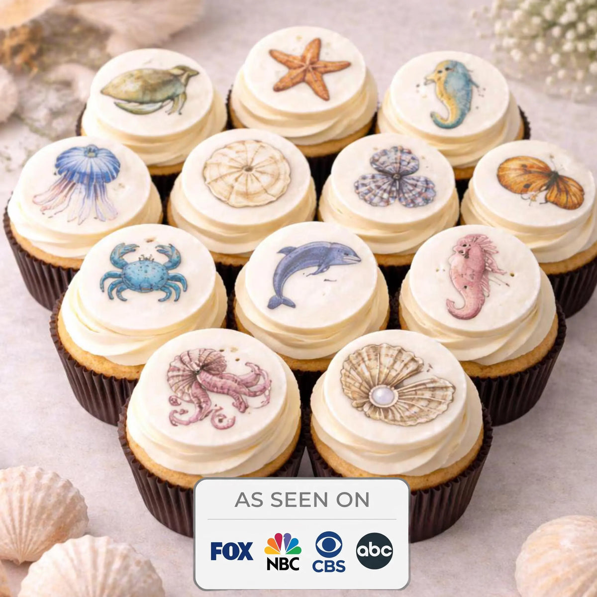 Set of 12 edible ocean-themed cupcake toppers featuring colorful sea creature designs by SugarPrints for decorating desserts.