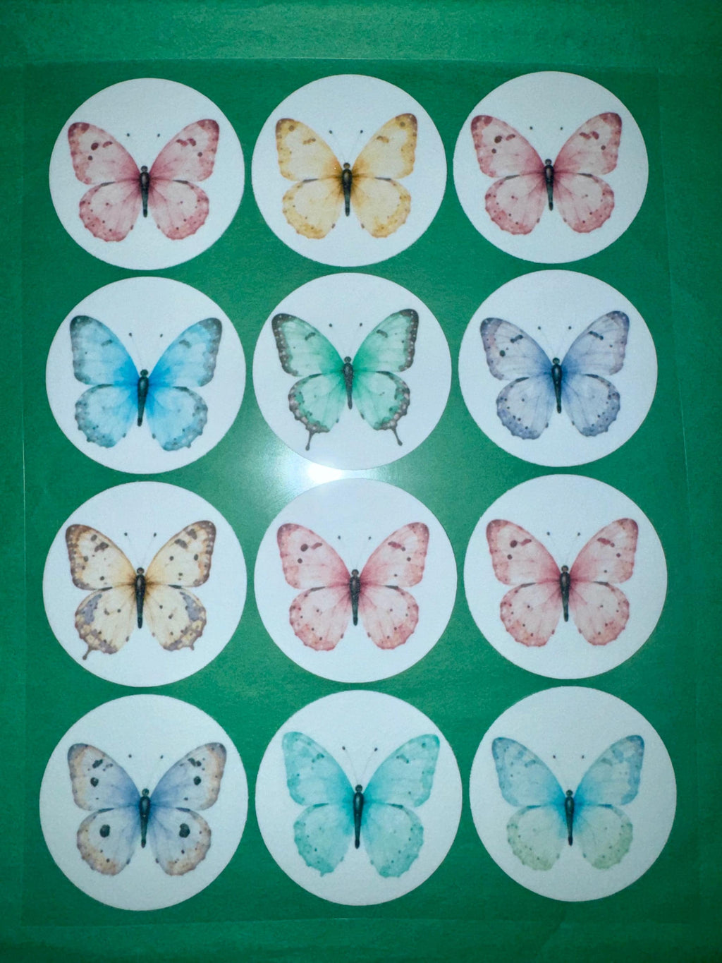 Set of 12 butterfly garden party cupcake toppers by SugarPrints, made of edible wafer paper or frosting sheet, for decorative desserts.