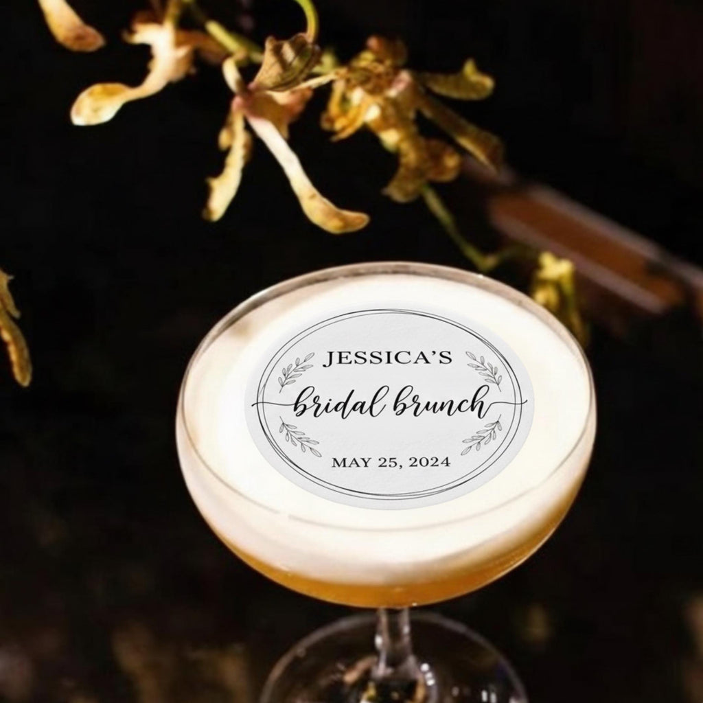 Wedding drink with a round edible wafer topper floating on latte foam.