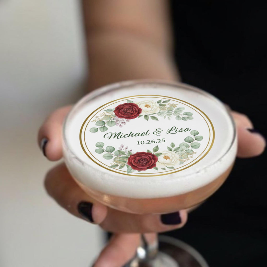 Set of 24 edible wafer paper floral wedding drink toppers with personalized names and date for signature cocktails.