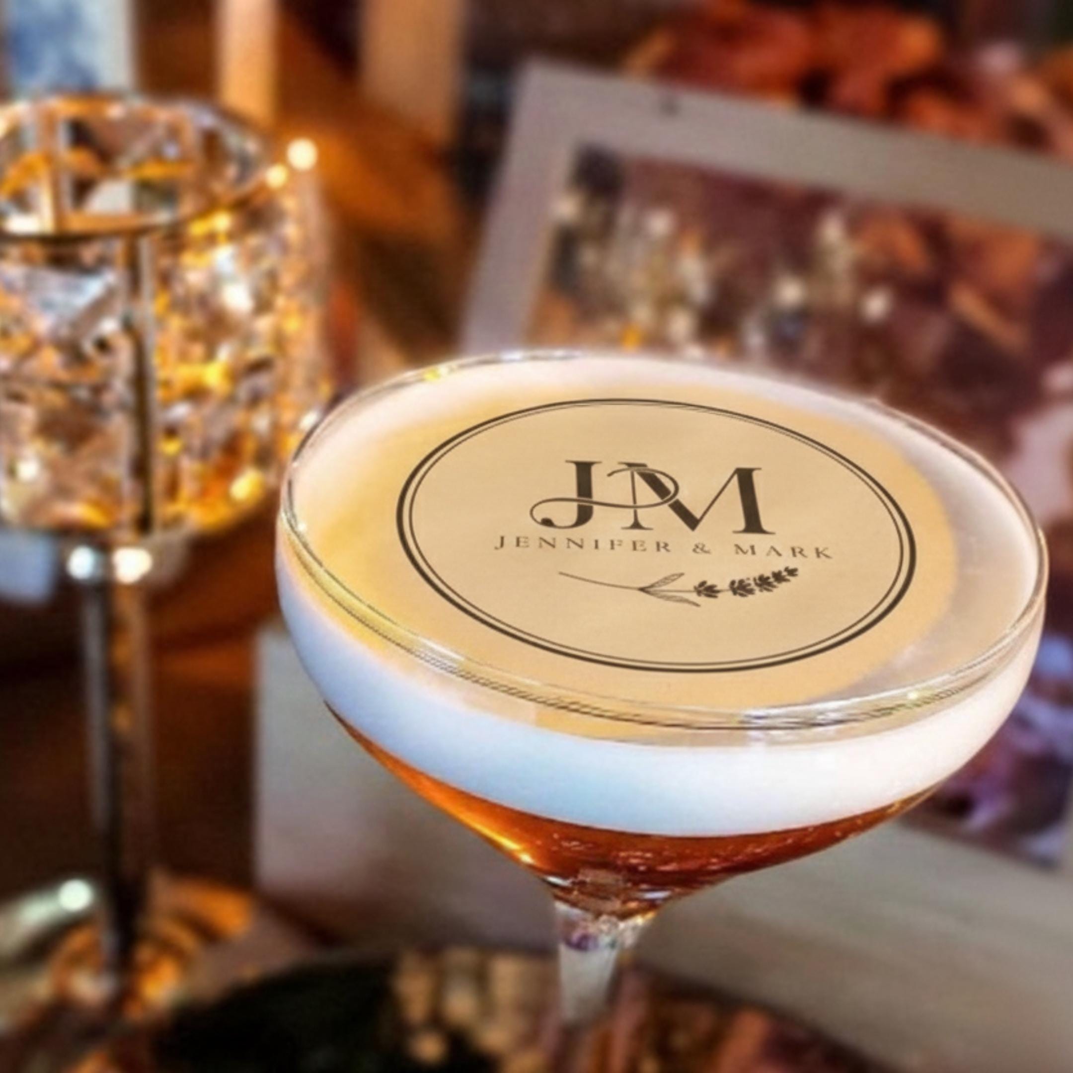 Set of personalized wedding drink toppers with custom initials on edible wafer paper for cocktail decorations.