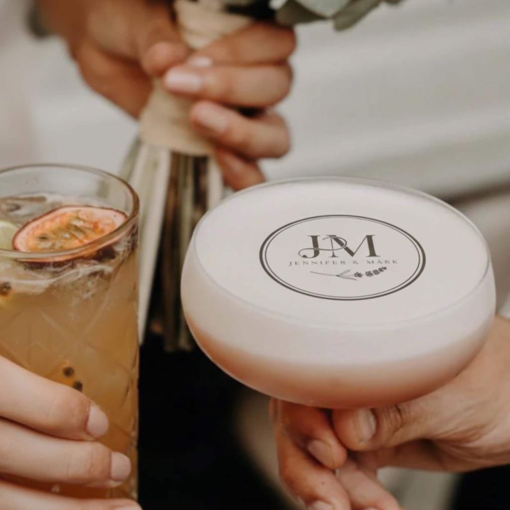 Personalized wedding drink topper with custom initials on edible wafer paper, designed for cocktail decorations.