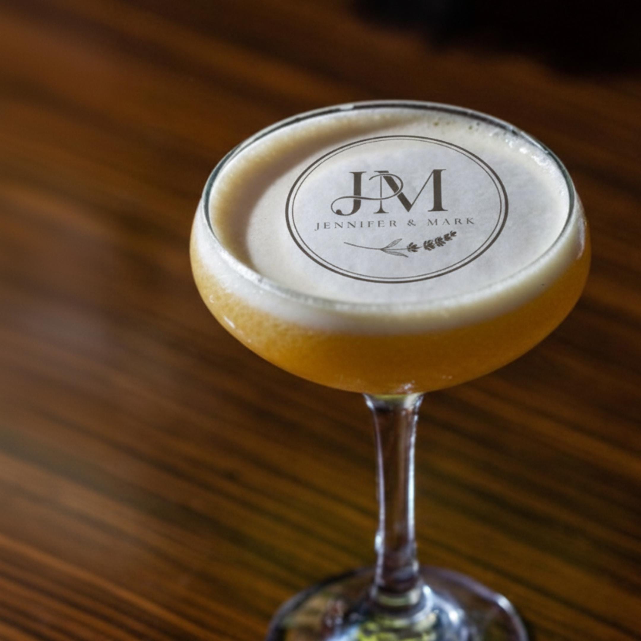 Personalized wedding drink topper with custom initials on edible wafer paper, perfect for cocktail decorations.