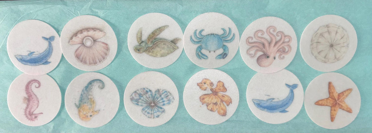 Set of 12 edible ocean cupcake toppers by SugarPrints, featuring vintage sea creature designs for beach-themed desserts.